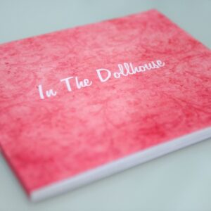 In the Dollhouse soft cover book a collection of essays, published pieces, interviews, candid photos, details and anecdotes about the project.