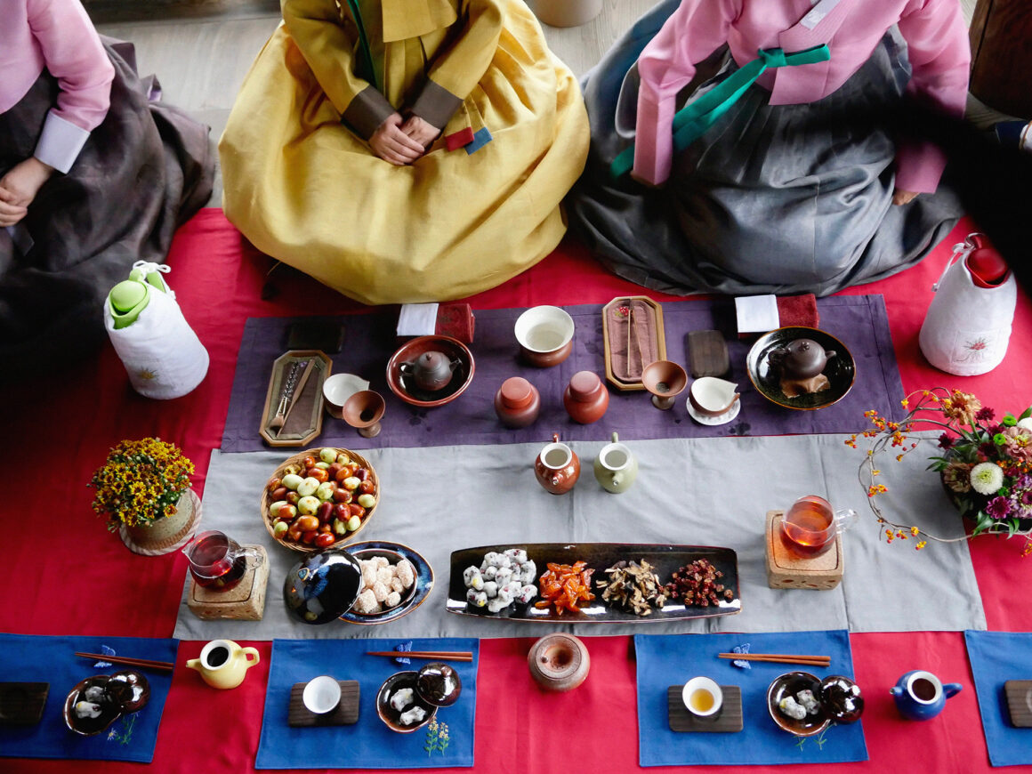 Image 1 Artist Dina Goldstein's photos taken in South Korea. Includes traditional tea party, street portraits and candids of people in everyday life.